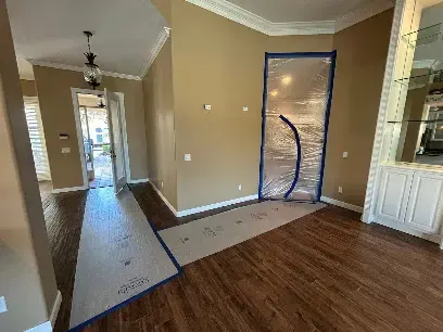Plastic containment wall sealing off a wet room in a Naples home