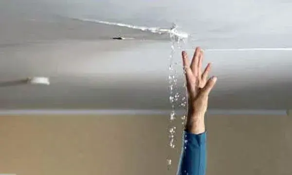 Water dripping from a cracked ceiling seam in a Naples home