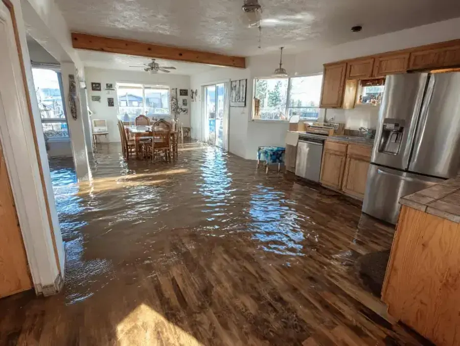 Storm surge floodwater standing across a coastal Naples kitchen and dining room